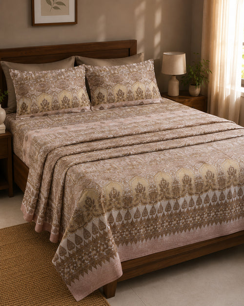 A bed dressed in a beige and brown patterned cotton sheet set with matching pillowcases, styled in a warm, neutral-toned bedroom.